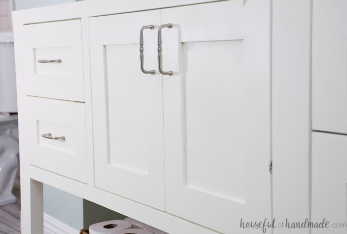 Close-up view of the cabinet doors and drawers with brushed nickel pulls on top of the DIY bathroom vanity. 