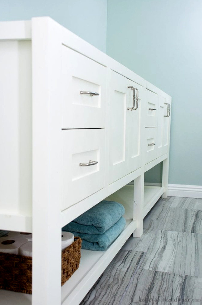 8' long white bathroom vanity designed to resemble a piece of furniture. 