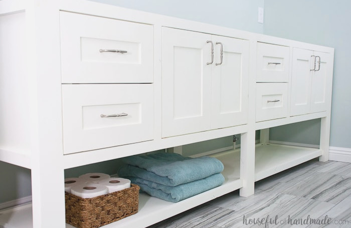 With some basic woodworking knowledge, you can create your own bathroom vanity. Build an 8' double vanity for under $300 as a budget-conscious DIY renovation. Download the free plans for this mission-style open-shelf bathroom vanity from Housefulofhandmade.com