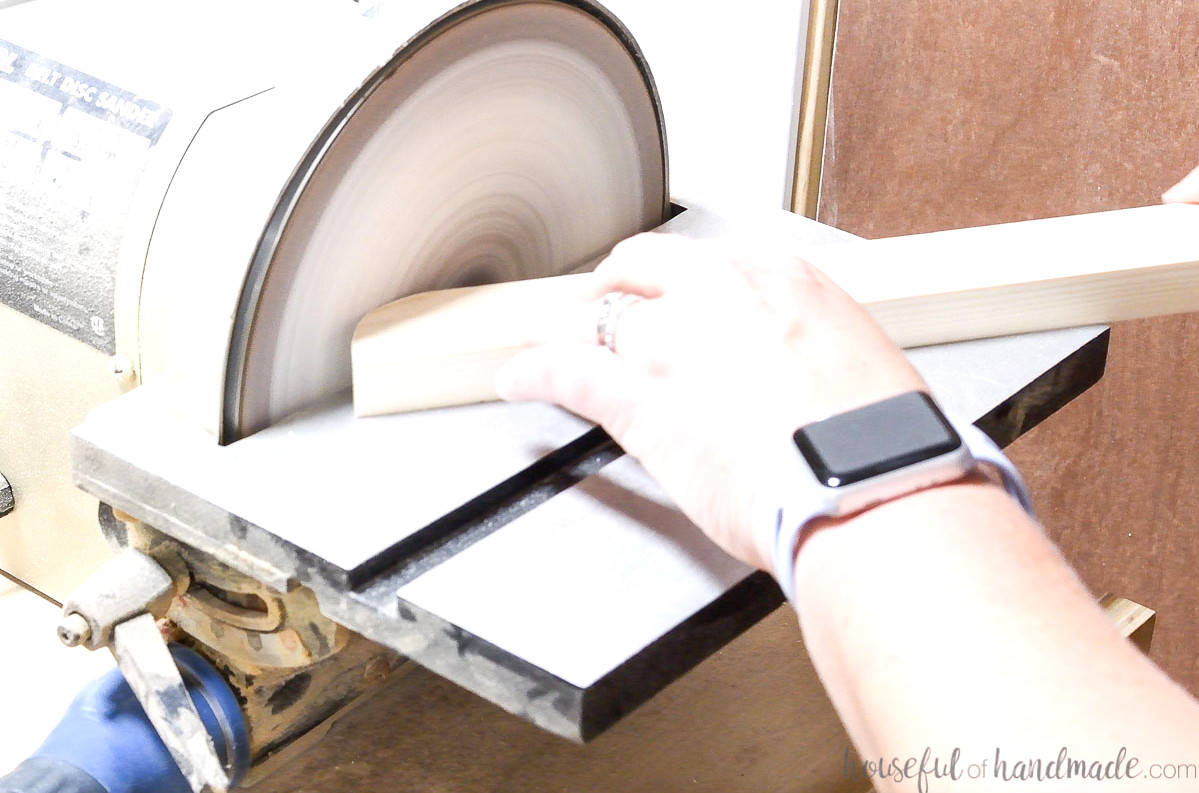 Sanding the curves on a disk sander.