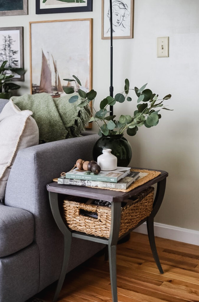 end table with a green vase and books