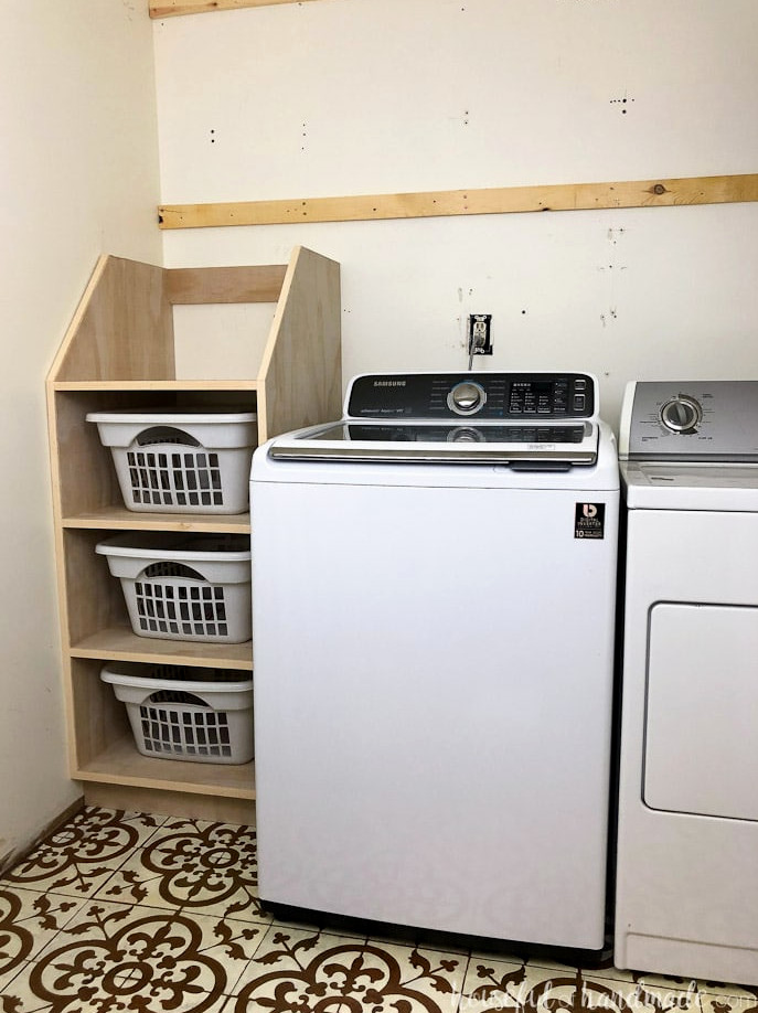 Stackable laundry basket storage shown in laundry room.