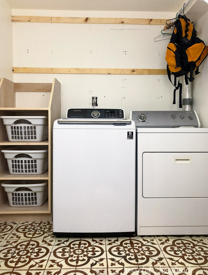 Laundry room with stackable laundry basket storage.
