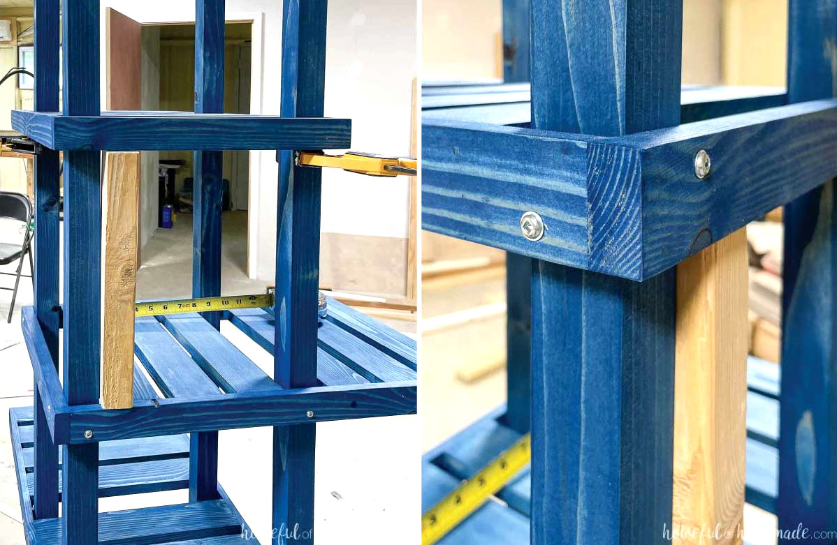 Using a scrap piece of wood to create spacing between the shelves on the tiered corner plant stand, with pan head screws positioned offset in the corners. 