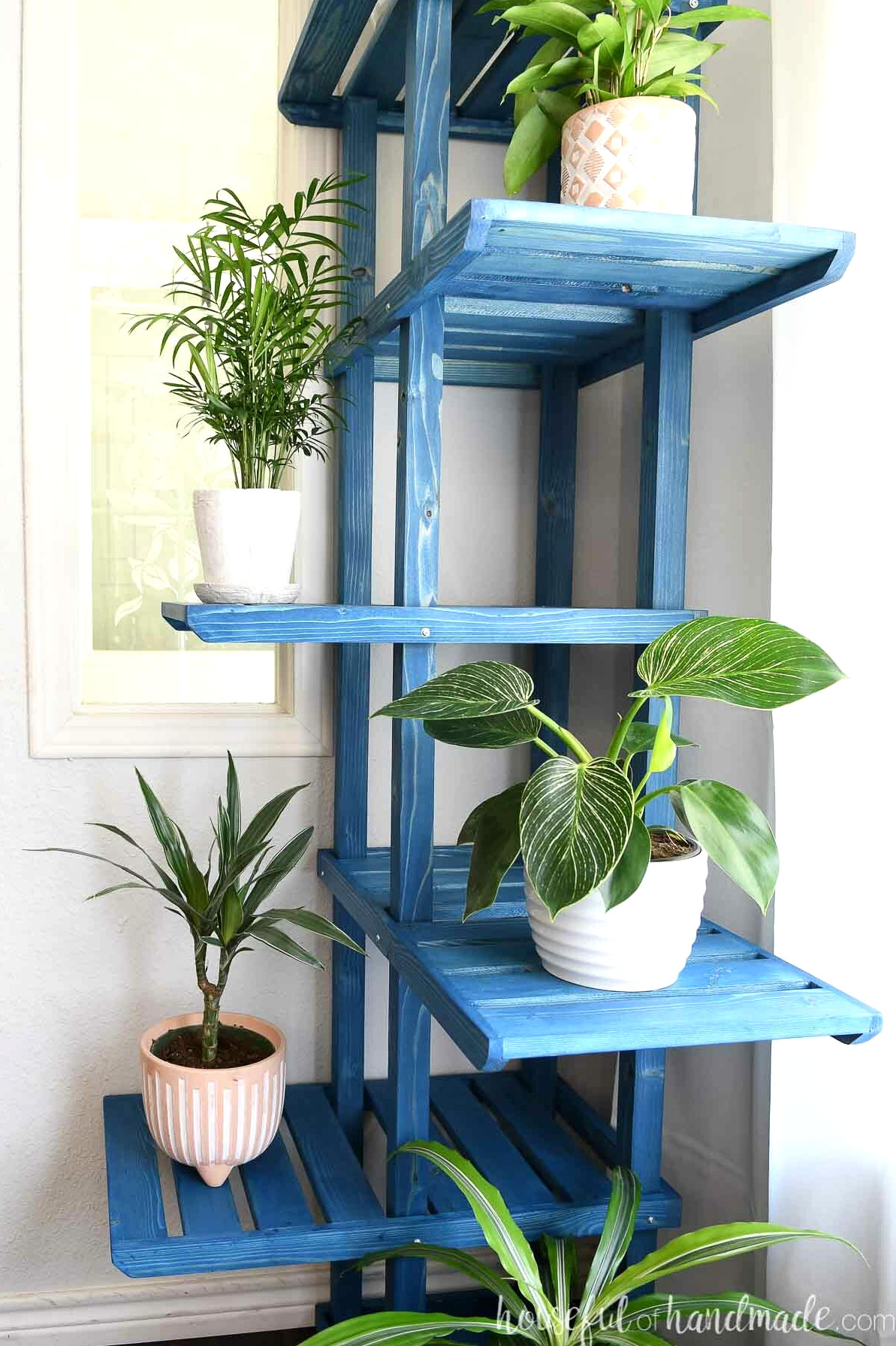 Detailed view of the spacious shelves on the corner plant stand. 