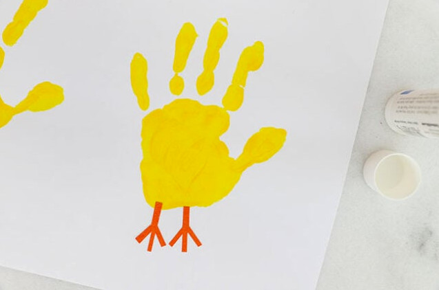 Feet glued onto handprint