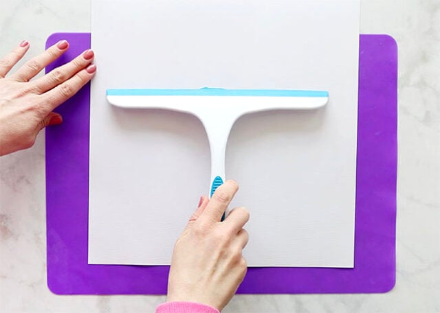 Squeegee positioned at page top