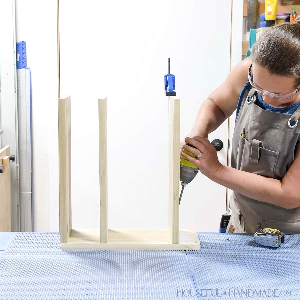 Attaching the top shelf on the larger side.