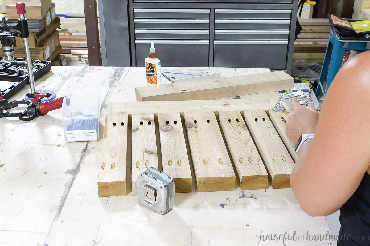 Fastening the middle table top boards to one of the table top side pieces.