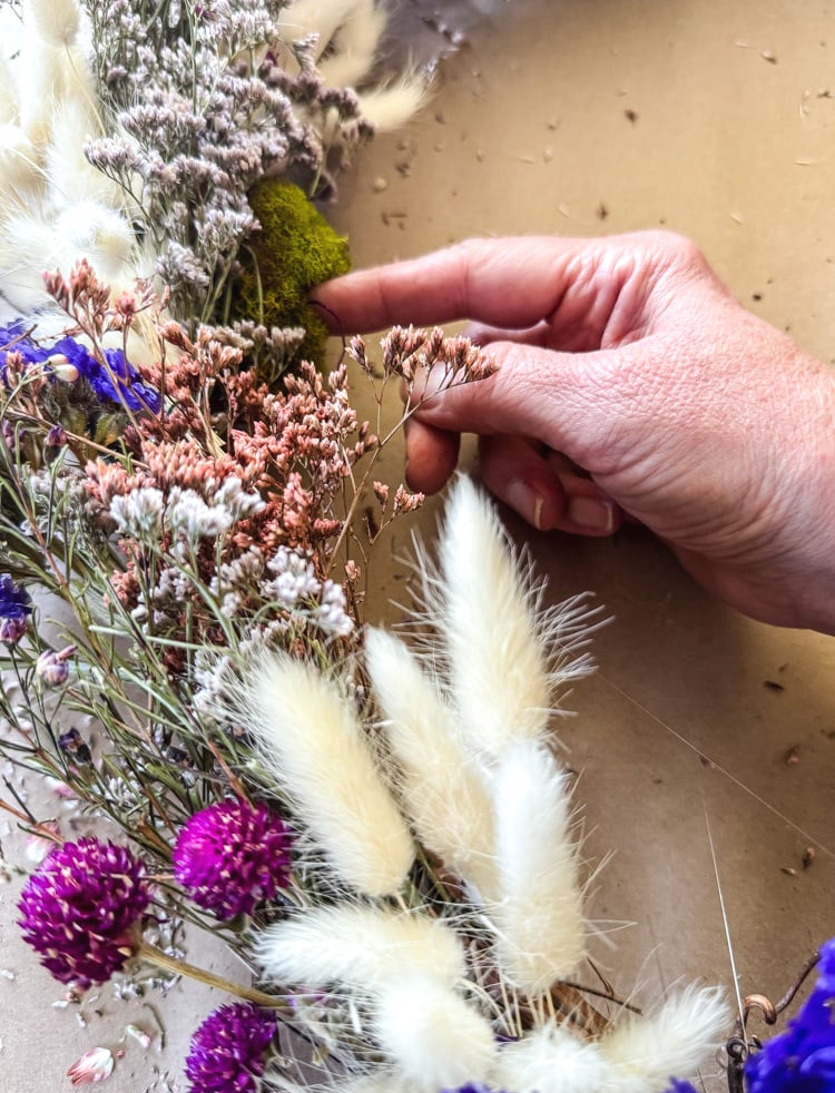 adding moss to a wreath