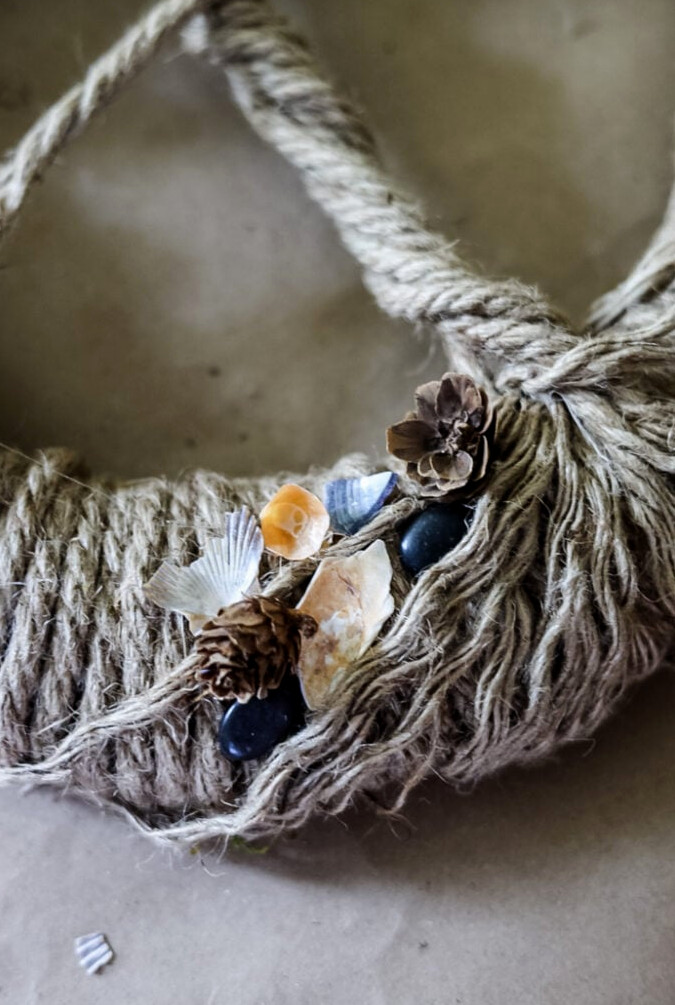 shells, pebbles, pinecones glued on tree of life wreath.
