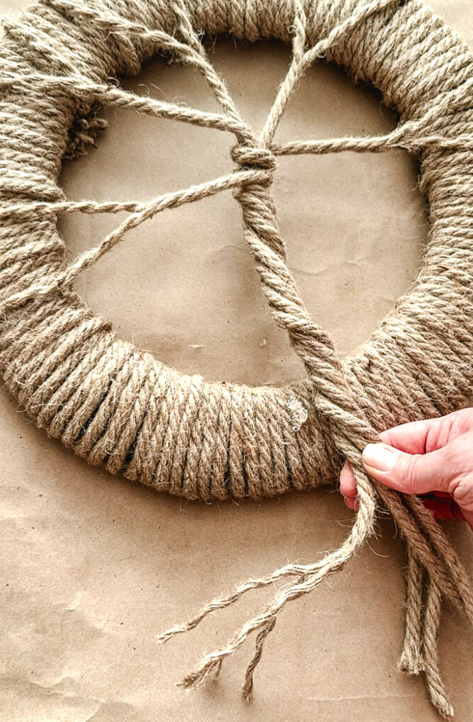 twisting rope to make a tree trunk for wreath
