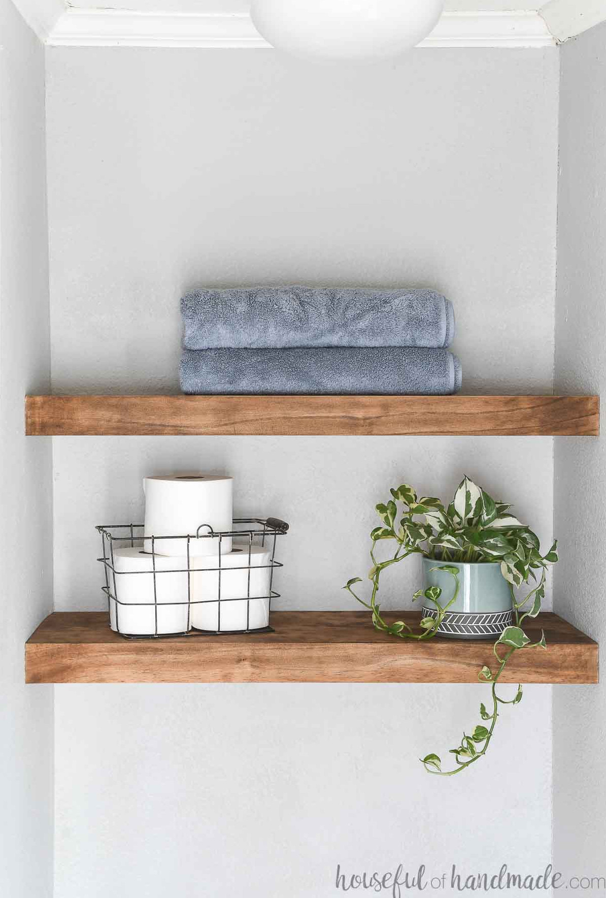 Small alcove with chunky wood shelves with no brackets in it.