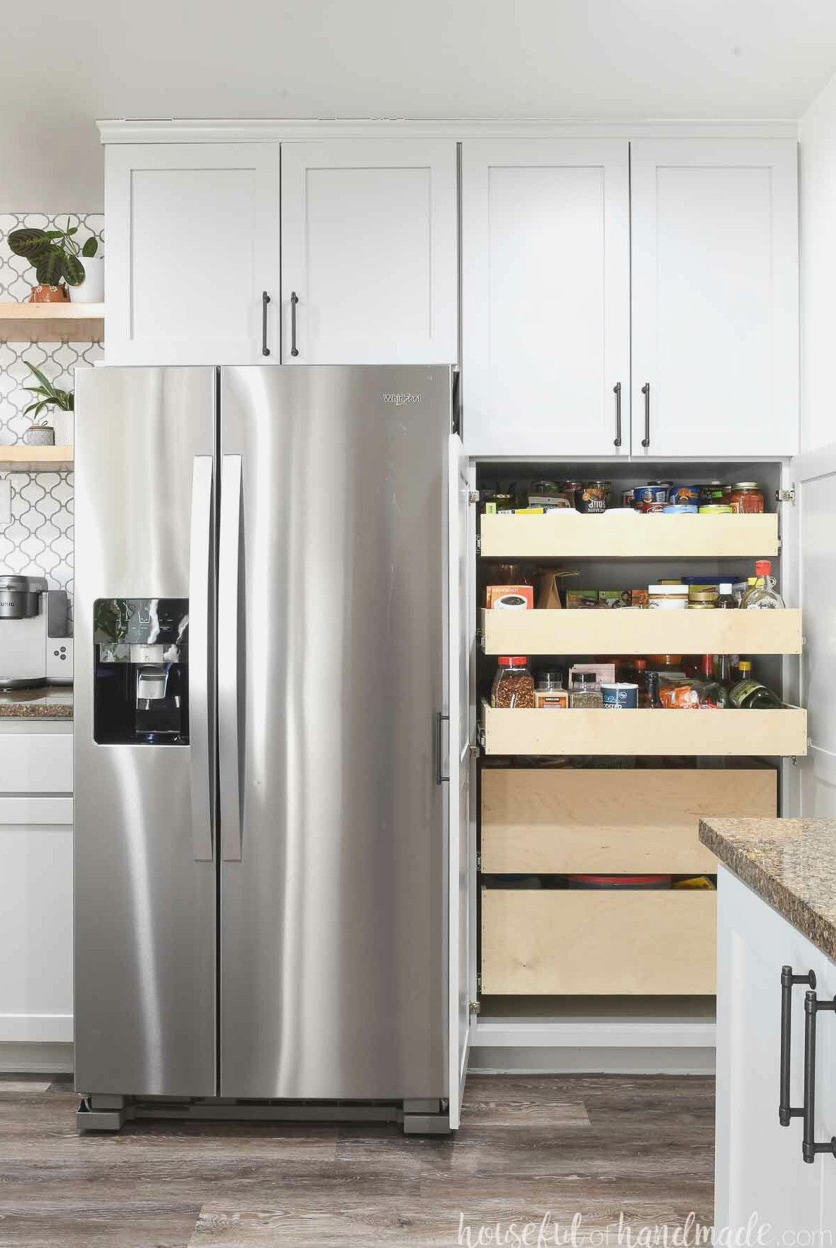 Pantry beside a refrigerator with two doors open, revealing the homemade sliding drawers inside.