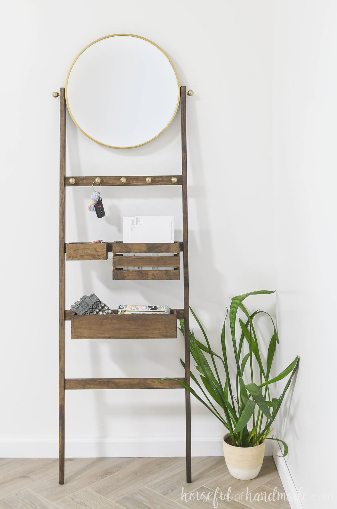 Entryway storage ladder with bins for mail, sunglasses, and gloves.