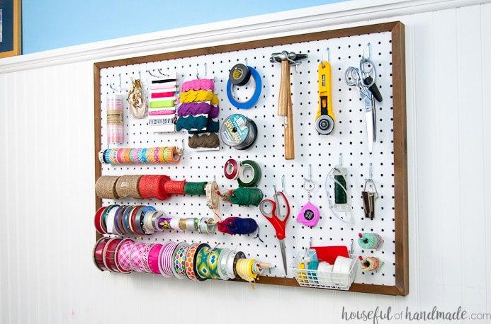 Make an ideal spot for arranging your most frequently used supplies! Discover how to mount pegboard so it can be removed whenever necessary. Housefulofhandmade.com | Craft organization ideas | Craft room remodel | Pegboard organization | $100 Room Challenge | Easy woodworking | Easy building plans | Free Building plans