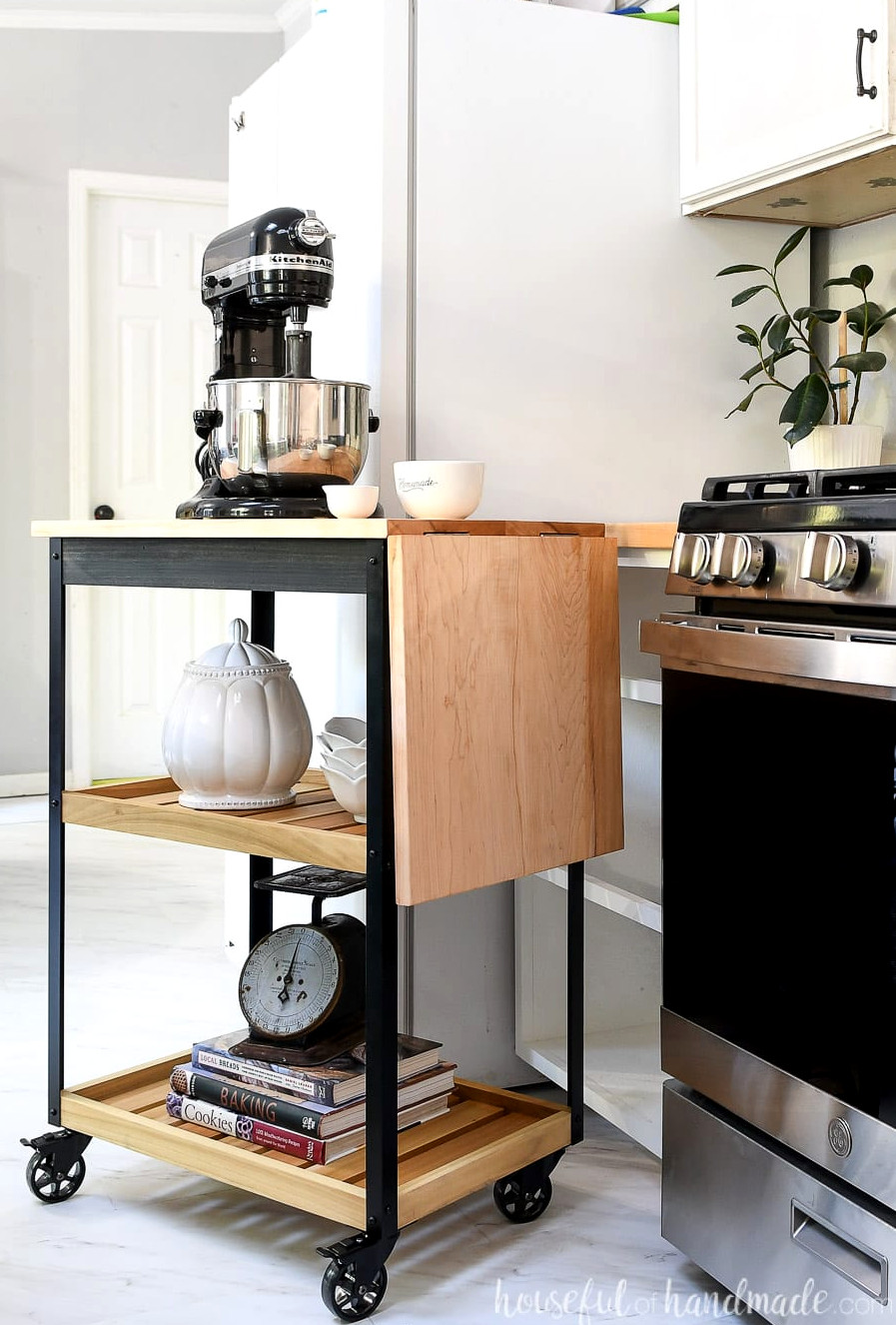 Side view of the rolling kitchen cart with its leaf lowered.