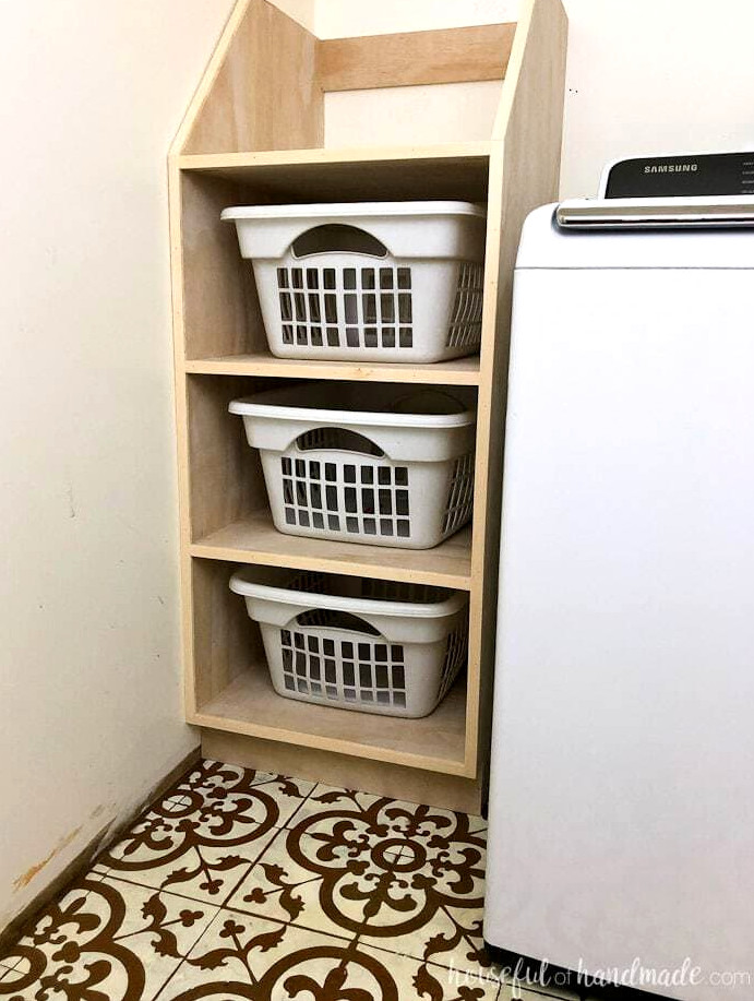 Try these fantastic DIY projects to arrange your home this year. Organize the laundry room with this stacked laundry basket storage unit. This simple-to-construct shelving system is an excellent laundry basket organizer that keeps dirty clothing concealed. Get the building instructions from Housefulofhandmade.com.