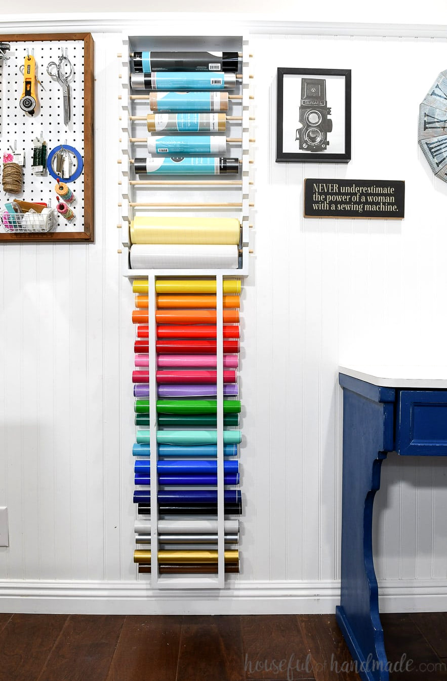 Full vertical view of the wall-mounted vinyl roll storage rack filled with vinyl.