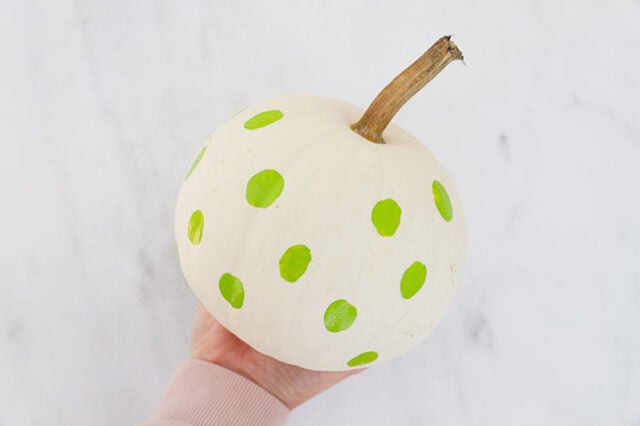 Green Frankenstein spots covering pumpkin