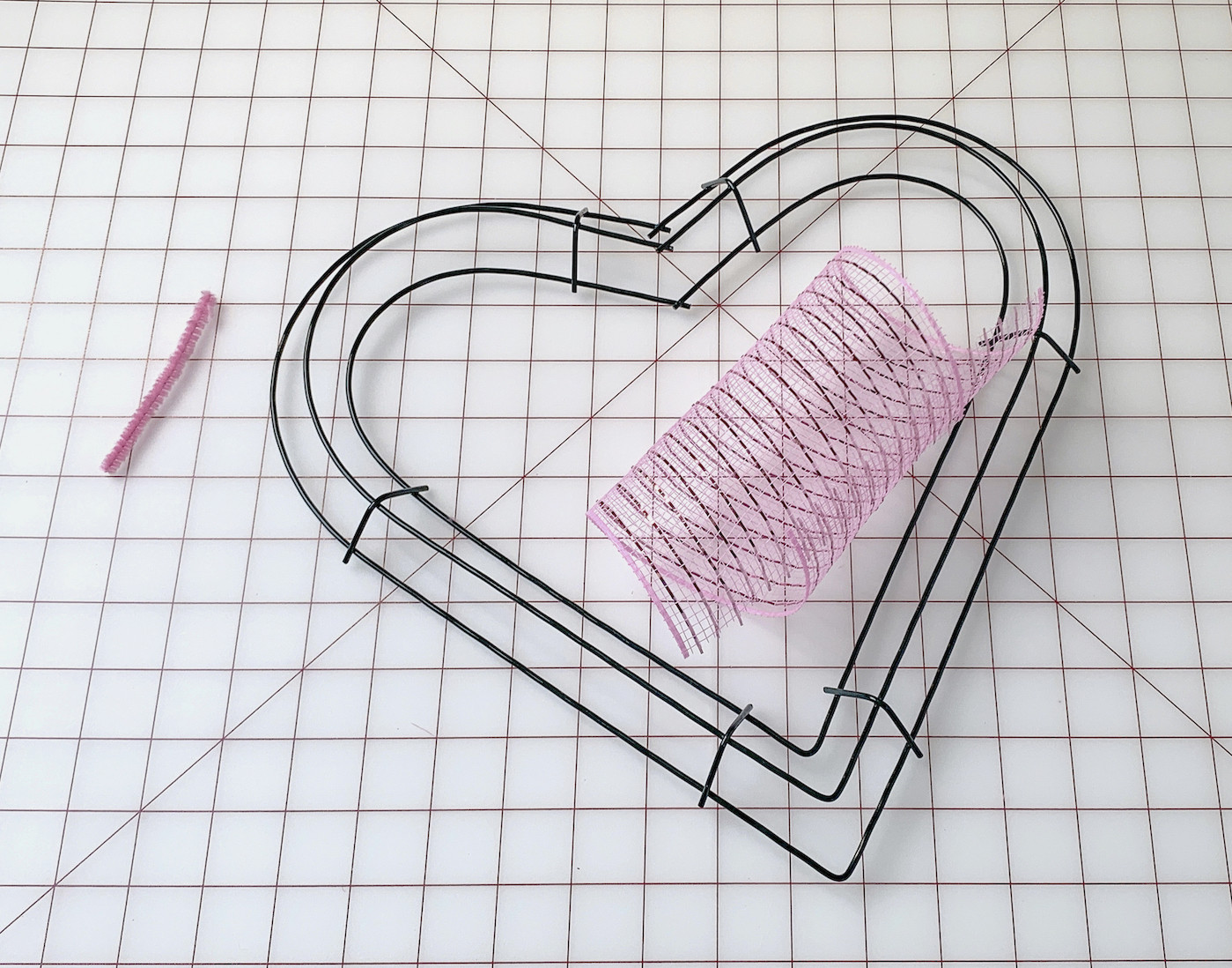 Heart wire wreath form, pipe cleaner, and piece of deco mesh