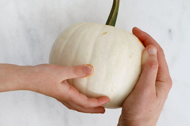 Stamping orange dots onto pumpkins