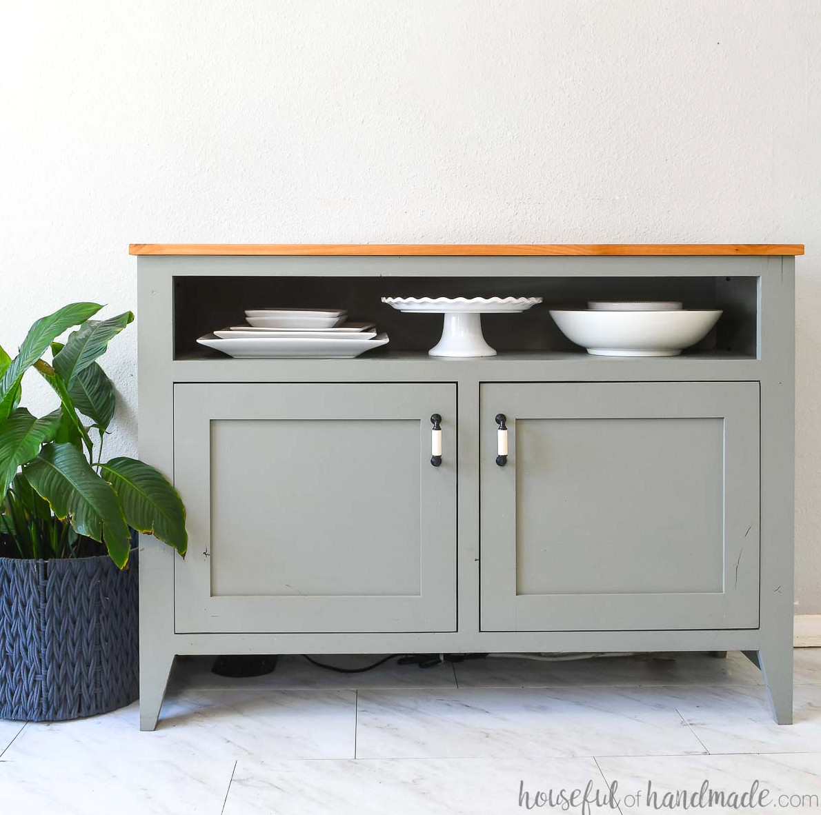 DIY sideboard table with two doors below and an open shelf on top for serving dishes.