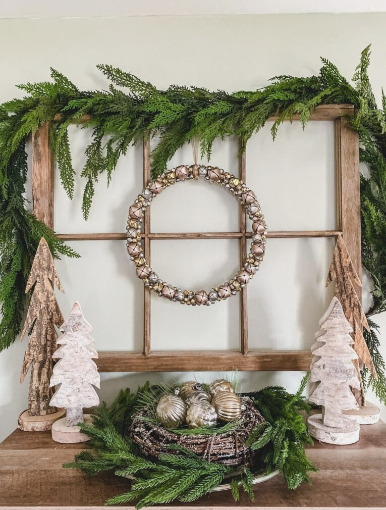 window frame with jingle bell wreath and wood trees