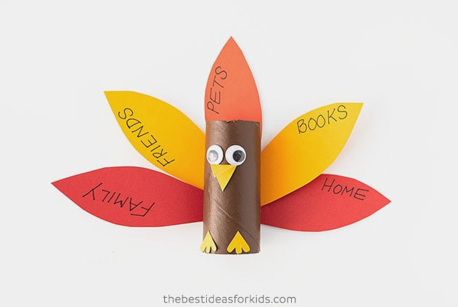 Attach the feathers to the paper roll