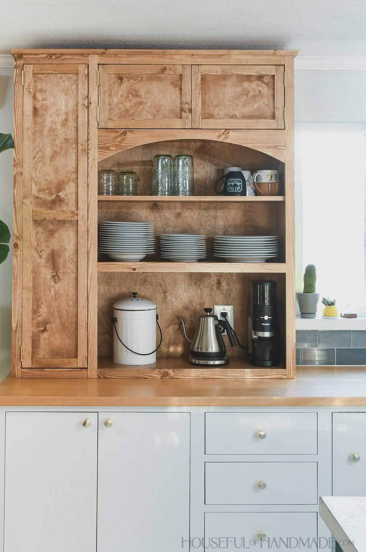 Large kitchen hutch with small cabinet on one side for appliances and lots of shelves. 