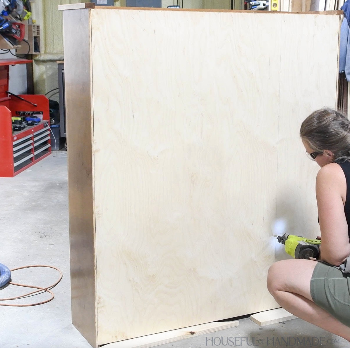 Fastening the cabinet back with brad nails. 