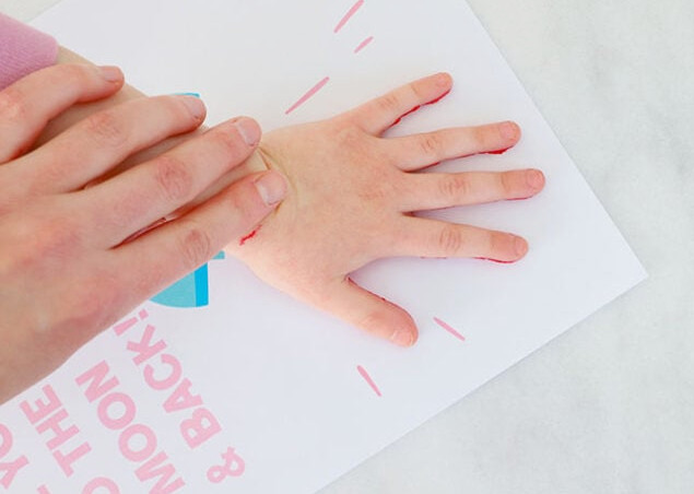 Pressing a handprint onto rocket paper