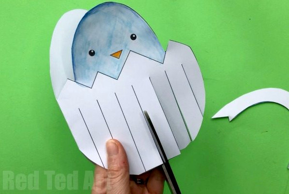 Cutting strips into Easter Egg paper weaving