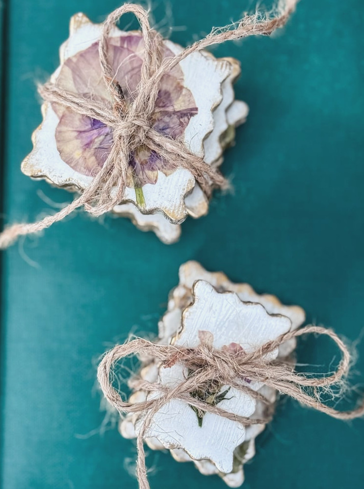 bundles of pressed flower postage stamped shape magnets tied with twine