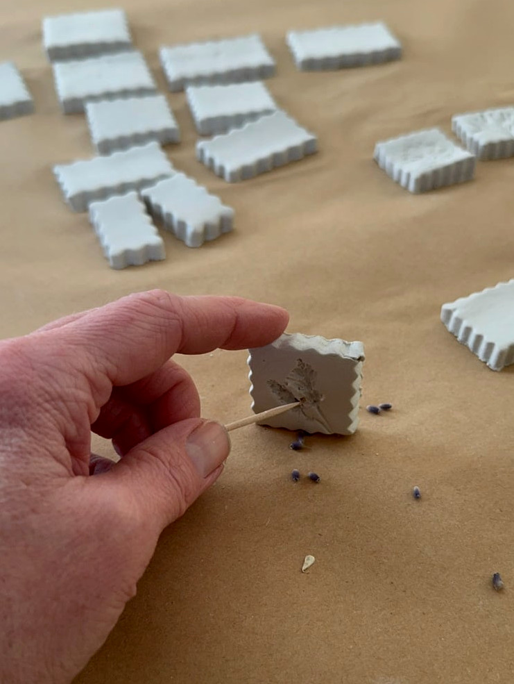 removing flower pieces from clay with a toothpick