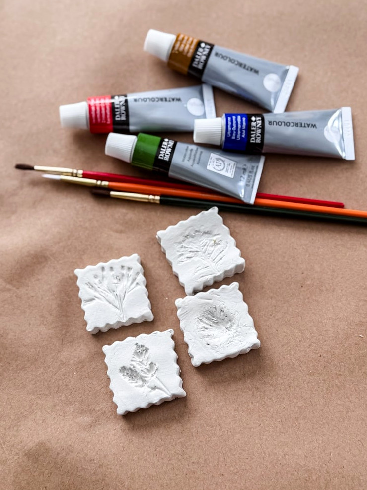 clay flower magnets and watercolor paint tubes