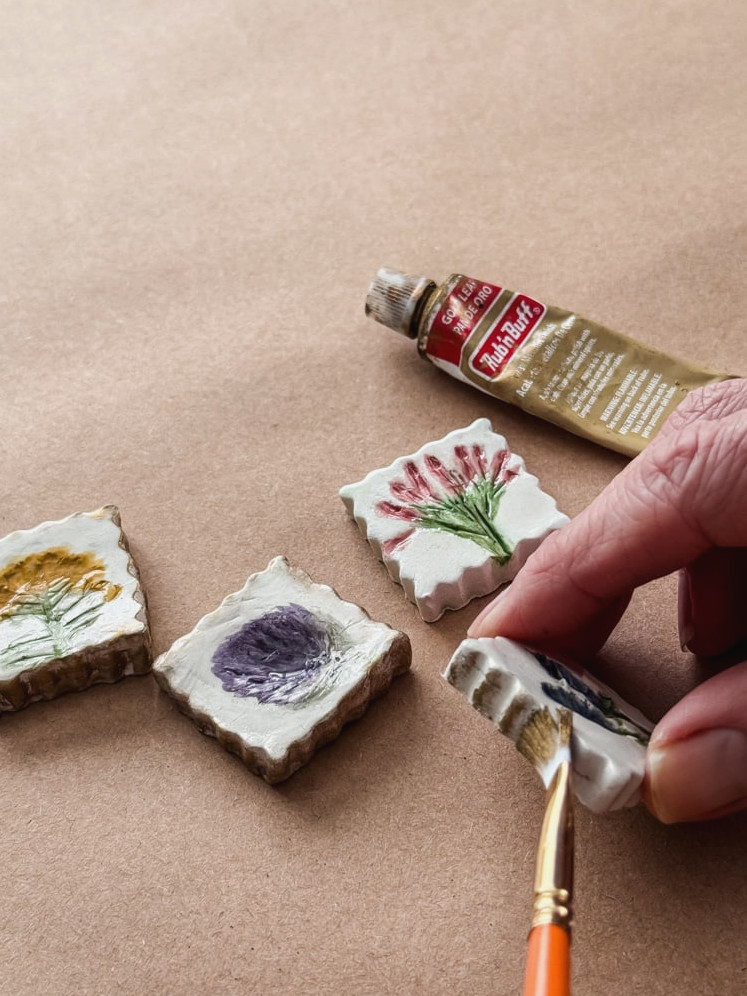 brushing rub and buff on a clay magnet