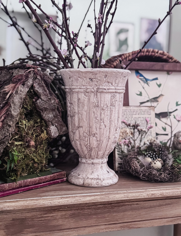 vase of cherry blossoms in vintage vase on table with mirror