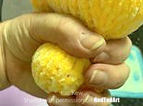 stuffing the knitted rubber duck's head to shape it