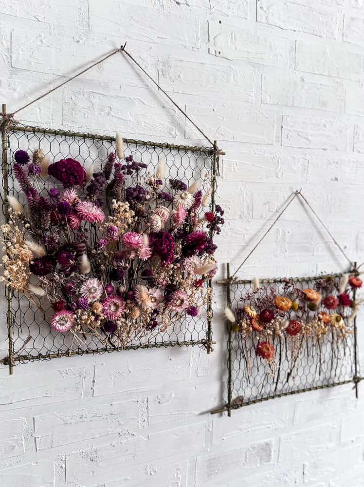 two hanging frames decorated with dried flowers