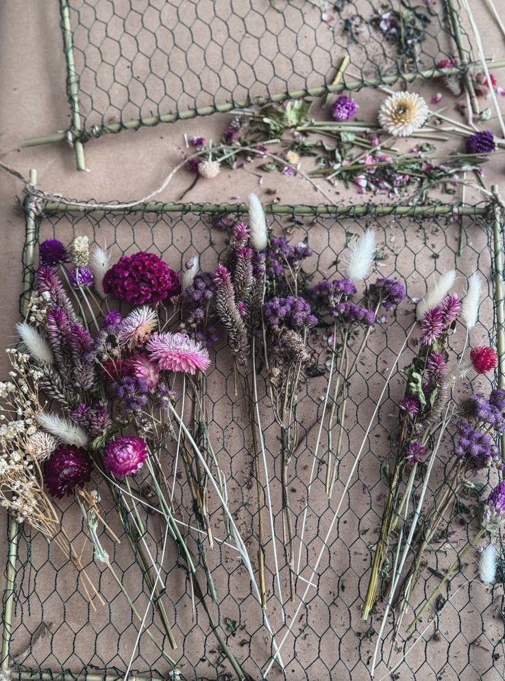 dried blossoms arranged on a chicken wire frame