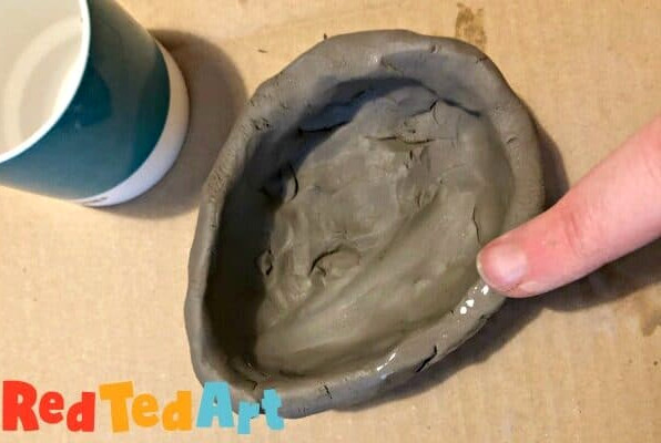 Smoothing your pinch pot down with water