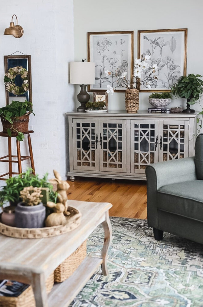 living room with console cabinet with lamp and flowers