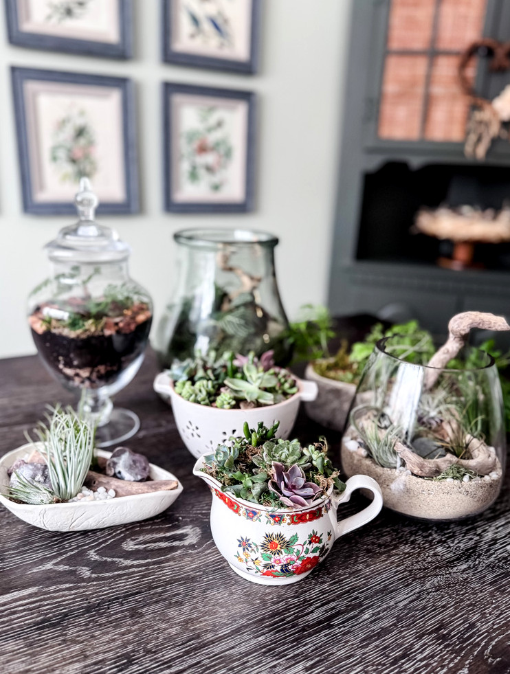 a table displaying 7 unique planters crafted from thrifted treasures