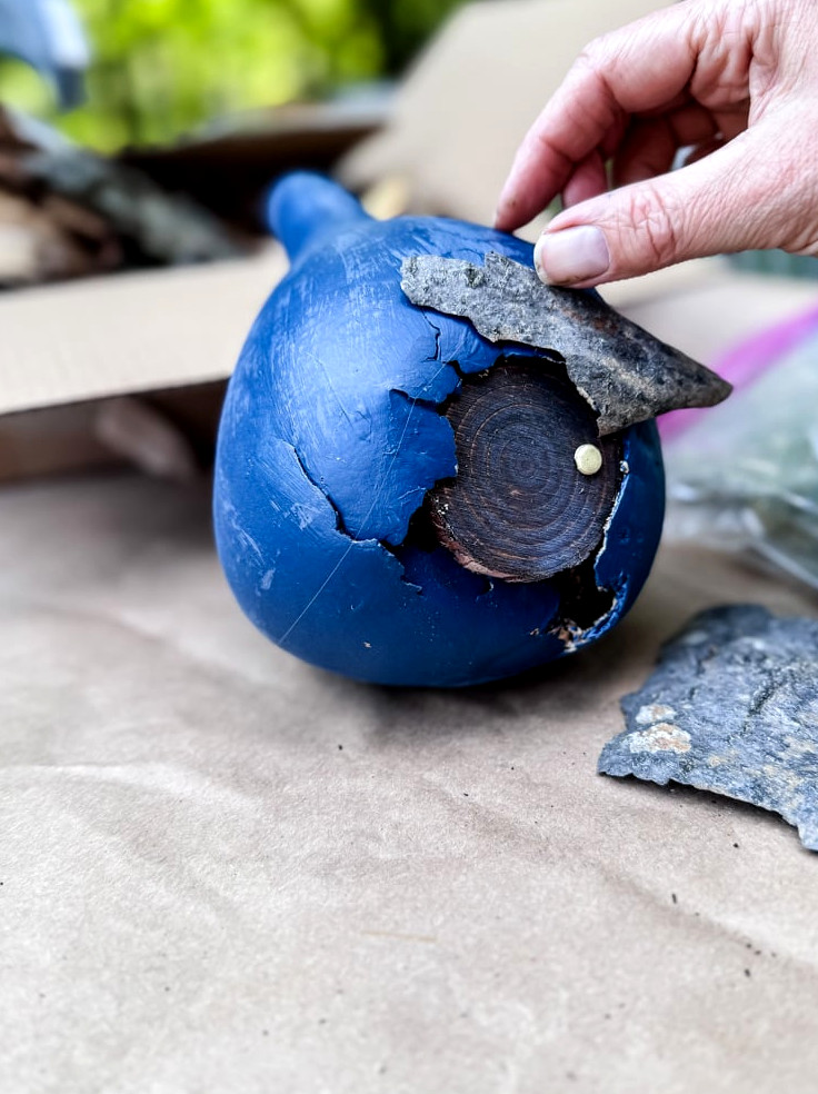 gluing bark onto a fairy house