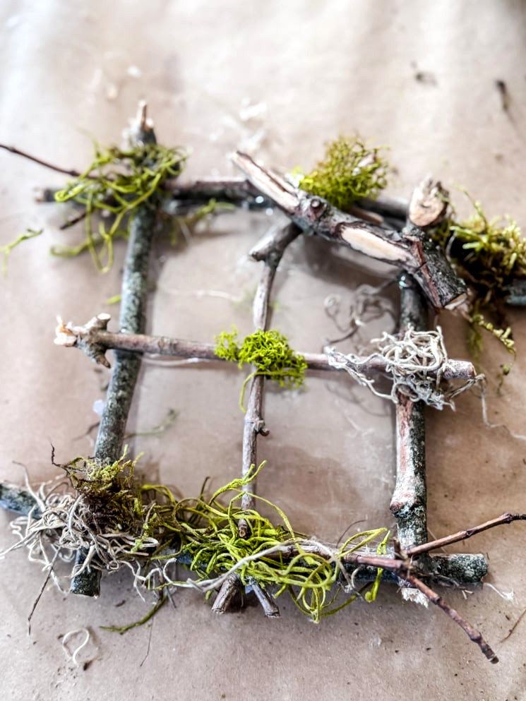 fairy tree window crafted with twigs and moss, use transparent plastic as the window glass