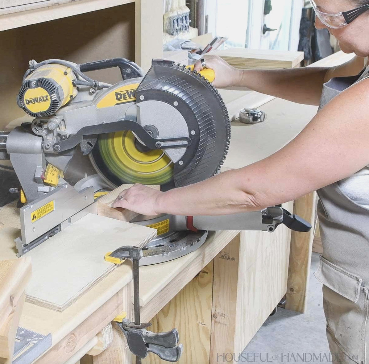 Cutting a 2x4 with an angle on both sides using a miter saw.