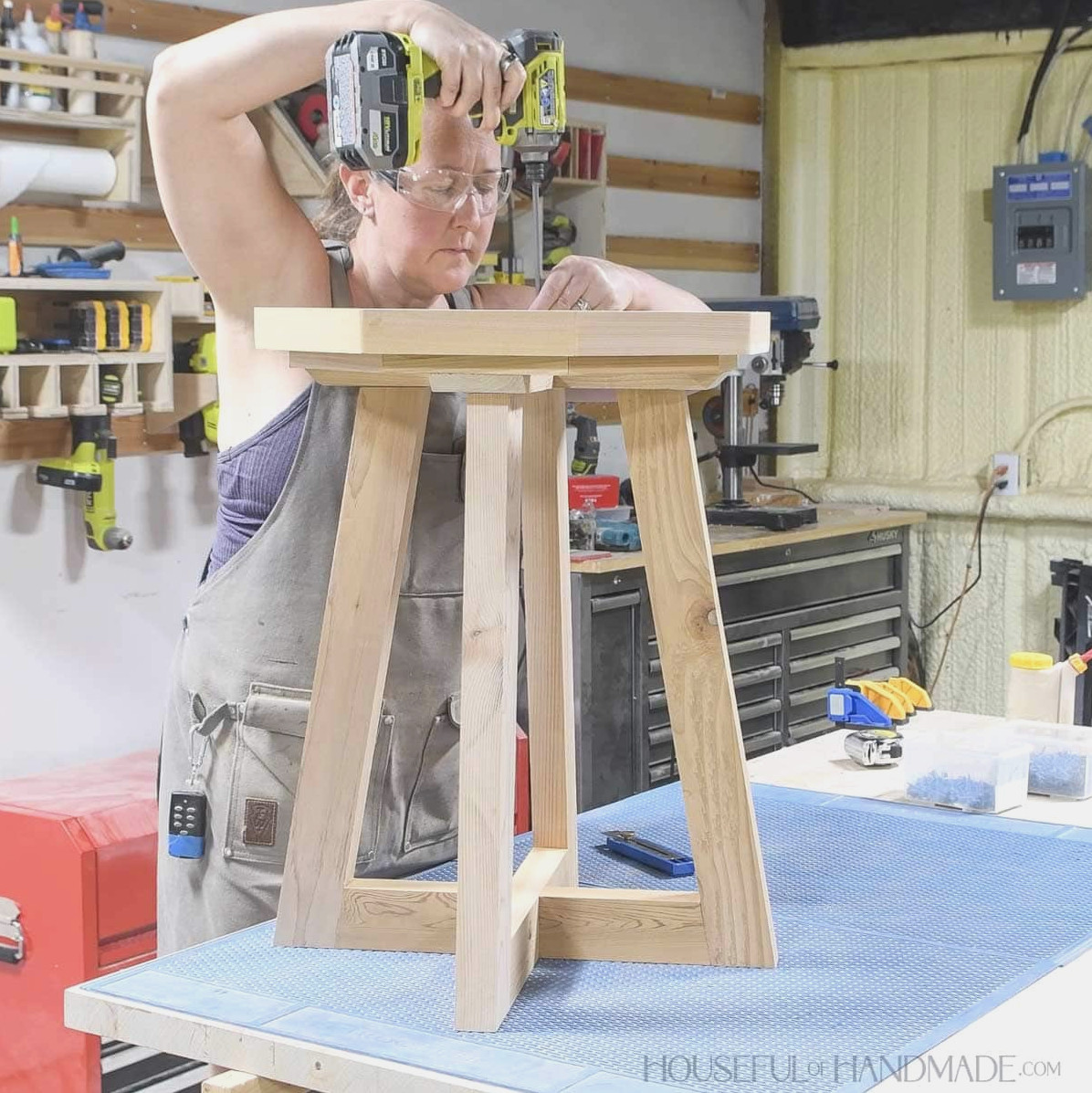Fastening the birdbath top to the pedestal legs.