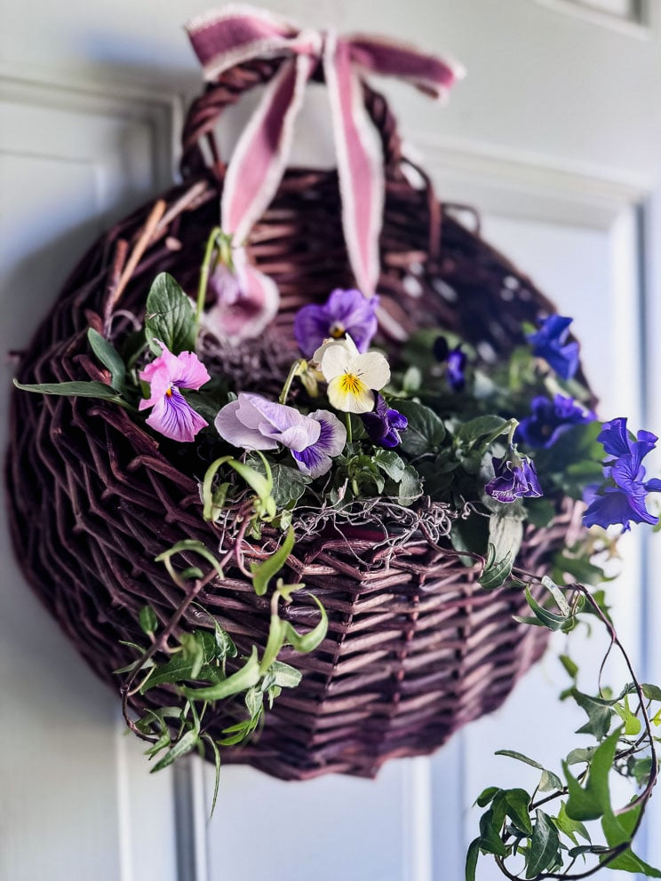 a door basket filled with pansies