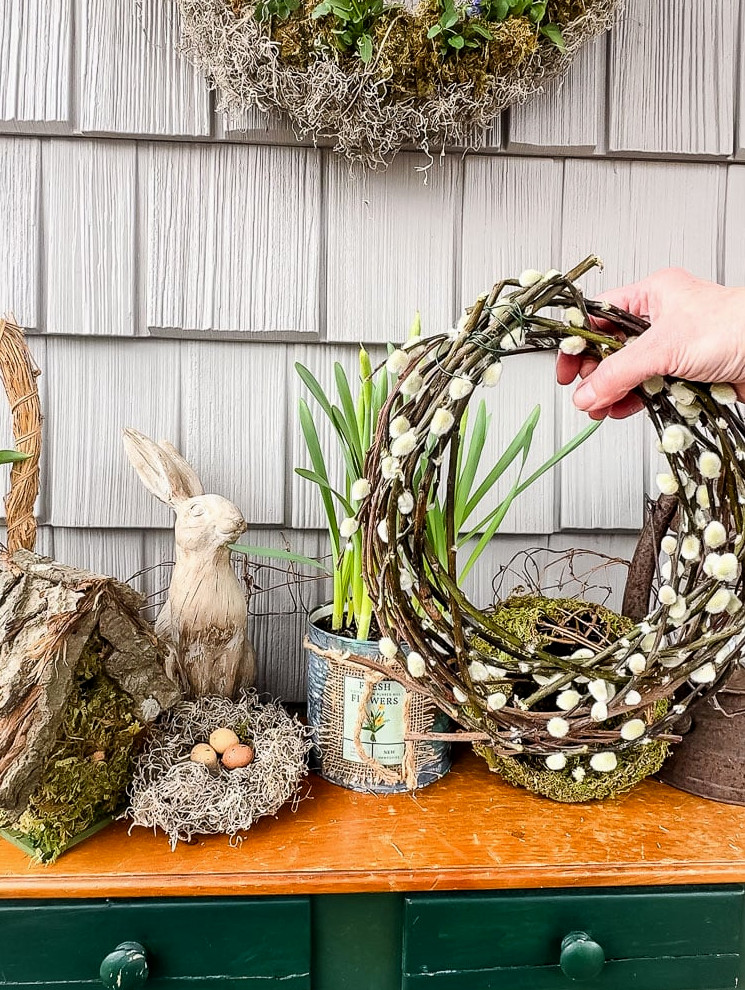 holding a pussy willow wreath